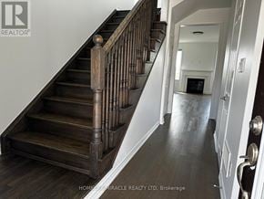 Milton (Cb Cobban) apartment for rent - A wooden staircase with a white wall on the side.