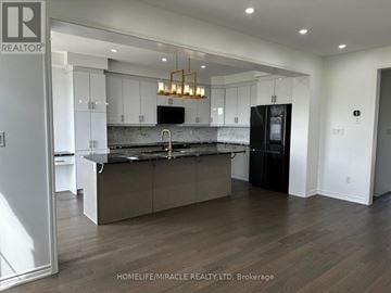 Milton (Cb Cobban) apartment for rent - A modern kitchen with a black refrigerator and wooden floors.