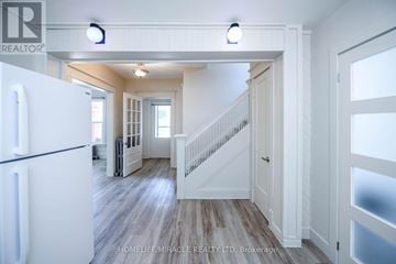Niagara Falls (Cherrywood) duplex for rent - A white refrigerator is in a kitchen with wood floors and white walls.