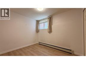 Vancouver apartment for rent - A room with a window and a wall-mounted air conditioner.