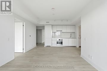 Toronto (Thorncliffe Park) condo for rent - A spacious kitchen with white cabinets and a stainless steel oven.