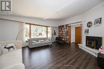 Burlington apartment for rent - A living room with a fireplace and a bookshelf filled with books.