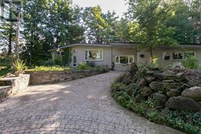 Burlington apartment for rent - A house with a stone wall and a brick driveway.