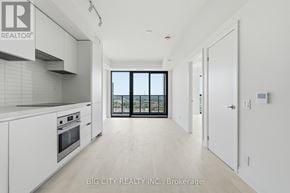 Toronto (Thorncliffe Park) condo for rent - A spacious kitchen with white cabinets and a large window.