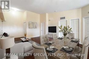 Milton (De Dempsey) condo for rent - A dining room with a table set for six and a television in the corner.
