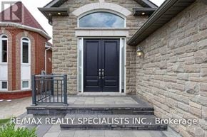 Mississauga (East Credit) apartment for rent - A house with a black door and a stone wall.
