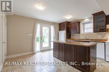 Mississauga (East Credit) apartment for rent - A kitchen with brown cabinets and a white fridge.
