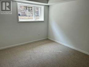 Toronto (New Toronto) townhouse for rent - A room with a window and a carpeted floor.