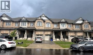 Kitchener townhouse for rent - A row of houses with cars parked in front.