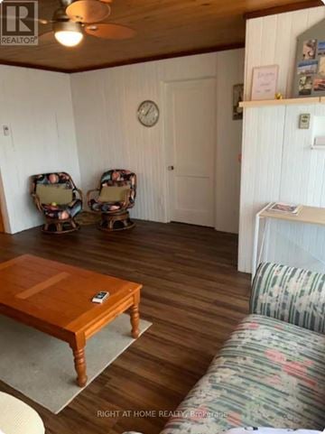 Tiny apartment for rent - A living room with a wooden table and two chairs.