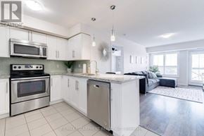 Milton (Wi Willmott) condo for rent - A modern kitchen with white cabinets and stainless steel appliances.