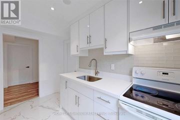 Toronto (Newtonbrook East) apartment for rent - A modern kitchen with white cabinets and a stainless steel oven.