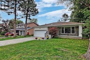 Toronto (Newtonbrook East) apartment for rent - A house with a garage and a tree in front of it.