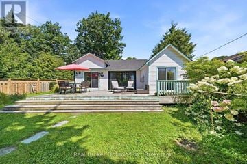 Tiny apartment for rent - A house with a red umbrella on the front porch.