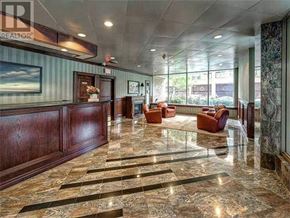 Toronto (Bay Street Corridor) condo for rent - A spacious lobby with marble floors and wooden paneling.