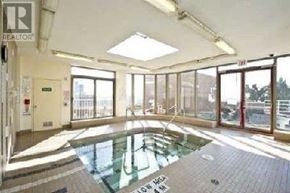 Toronto (Bay Street Corridor) condo for rent - A large indoor swimming pool with a glass ceiling.