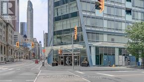 Toronto (Waterfront Communities) condo for rent - A city street with a building in the background and a traffic light on the right.