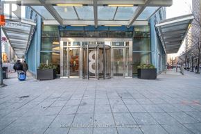 Toronto (Waterfront Communities) condo for rent - The entrance to a building with glass doors and a sign that says "REALTOR".