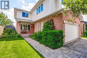 Waterdown apartment for rent - A house with a white garage door and a brick wall.