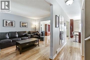 Waterdown apartment for rent - A living room with a black leather couch and a wooden coffee table.