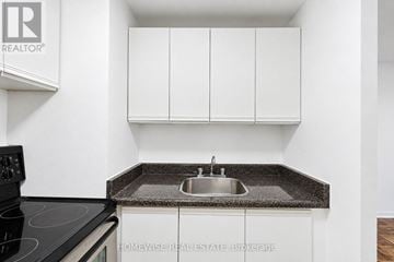 Toronto (The Beaches) multi-family for rent - A kitchen with a sink and cabinets.