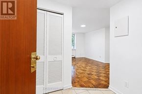 Toronto (The Beaches) multi-family for rent - A room with a wooden floor and a white door.