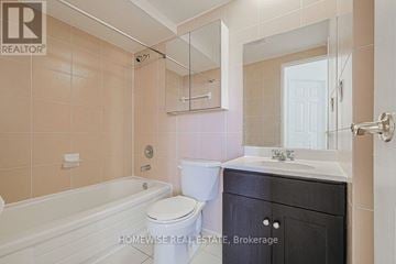 Toronto (The Beaches) multi-family for rent - A bathroom with a toilet, sink, and bathtub.