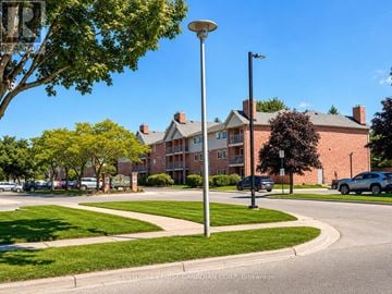 London South (South X) condo for rent - A street view of a residential area with apartment buildings and parked cars.
