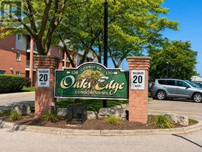 London South (South X) condo for rent - A sign for Oak's Edge Condominiums is displayed in front of a building.