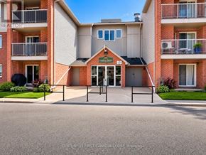 London South (South X) condo for rent - A building with a red brick facade and a sign that reads "CENTURY 21 FIRST CANADIAN CORP BROkerage".