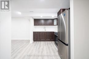 Oshawa (Taunton) apartment for rent - A kitchen with a refrigerator on the right side.