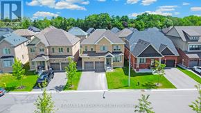 Clarington (Bowmanville) apartment for rent - A row of houses with the RE/MAX Metropolitan Realty logo in the foreground.