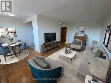 Toronto (Leaside) condo for rent - A living room with a grey couch and a coffee table.