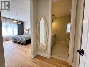 Kitchener apartment for rent - A bedroom with a large mirror and a bed.