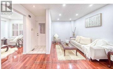 Toronto (Centennial Scarborough) apartment for rent - A living room with a white couch and a wooden coffee table.