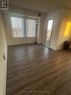 Toronto (Etobicoke West Mall) condo for rent - A room with wooden flooring and a window with blinds.
