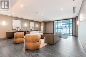 Hamilton (Waterdown) condo for rent - A spacious living room with a grey floor and a white ceiling.