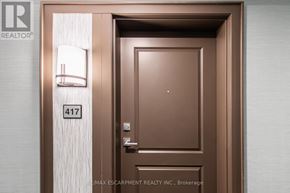 Hamilton (Waterdown) condo for rent - A brown door with the number 417 on it.