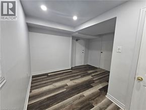 Hamilton apartment for rent - A room with wooden flooring and white walls.