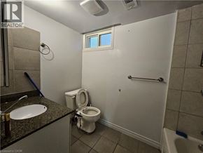 Hamilton apartment for rent - A bathroom with a toilet, sink, and shower.