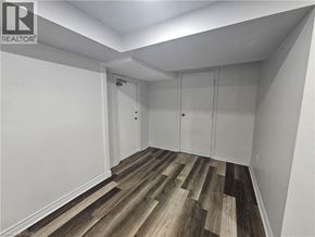 Hamilton apartment for rent - A room with wood flooring and white walls.