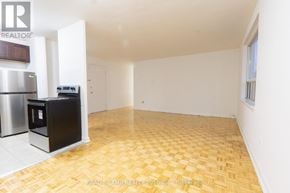 Toronto (Stonegate-Queensway) condo for rent - A kitchen area with a refrigerator and a microwave.