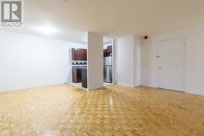 Toronto (Stonegate-Queensway) condo for rent - A room with a wooden floor and a white door.