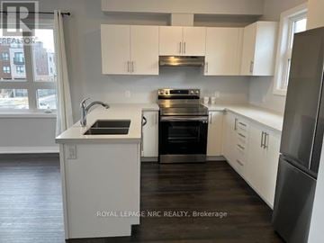 Niagara Falls (Morrison) townhouse for rent - A modern kitchen with white cabinets and stainless steel appliances.