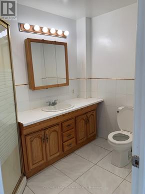 Caledon (Palgrave) apartment for rent - A small bathroom with a toilet, sink and mirror.