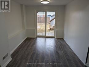 Innisfil (Alcona) townhouse for rent - A room with a sliding door leading to a backyard.