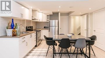East Gwillimbury apartment for rent - A modern kitchen with a dining table set for four.