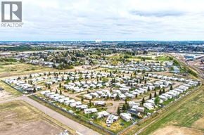 Lloydminster apartment for rent - A bird's eye view of a residential area with houses and a road.