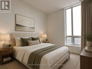 Toronto (Henry Farm) condo for rent - A bedroom with a large bed, a nightstand with a lamp, and a painting on the wall.