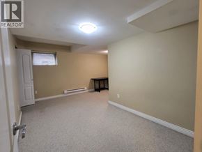 Coquitlam apartment for rent - A room with a carpeted floor and a small table in it.